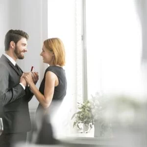 Elegant Couple With Engagement Ring In Restaurant