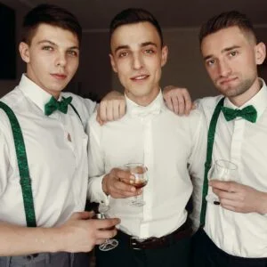 Stylish Handsome Groom With Groomsman Hugging And Holding Whiskey In Glass
